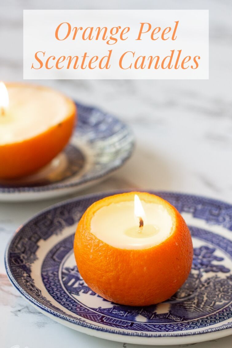 two orange peel candles on blue and white china plates