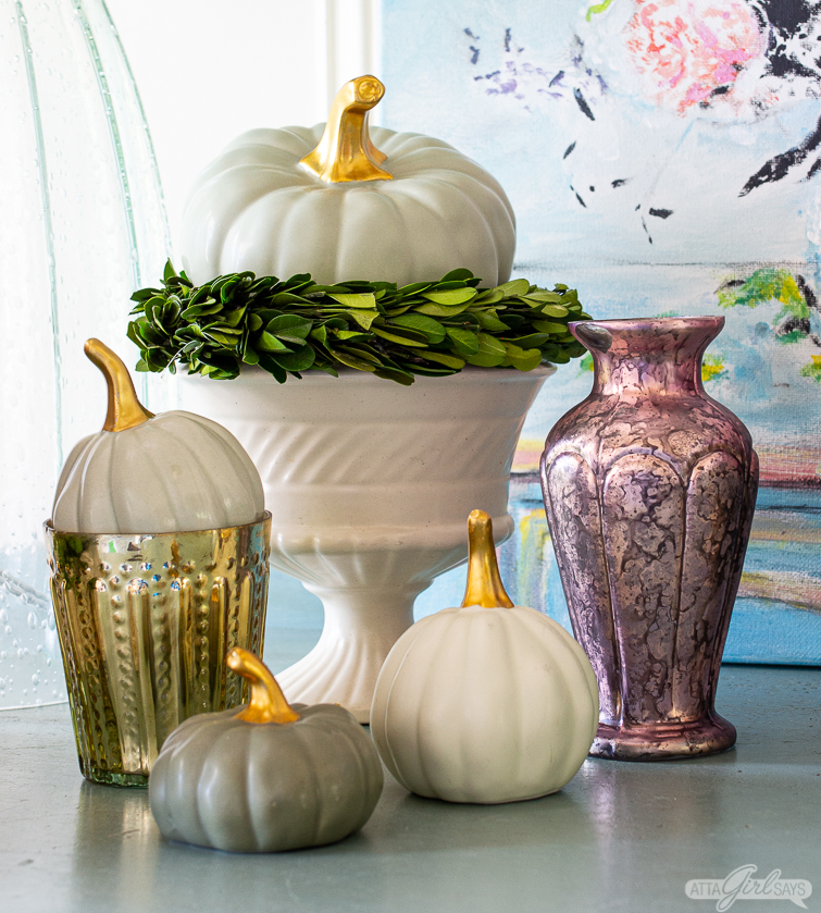 ceramic pumpkins, vintage pottery and mercury glass votives and vases on a painted buffet