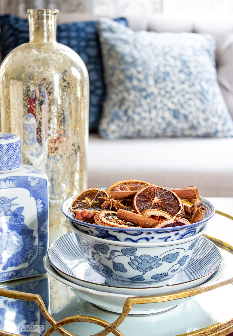 chinoiserie bowl of Christmas potpourri sitting on a mirrored tray in a living room