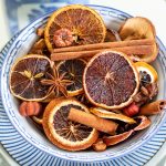 dried oranges and cinnamon stick Christmas potpourri in a blue and white bowl