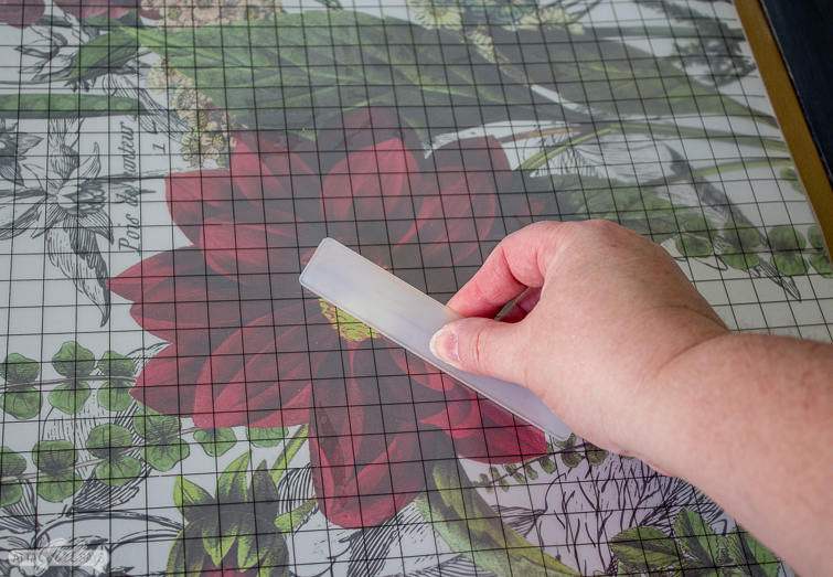 applying a decorative rub-on transfer to a folding game table