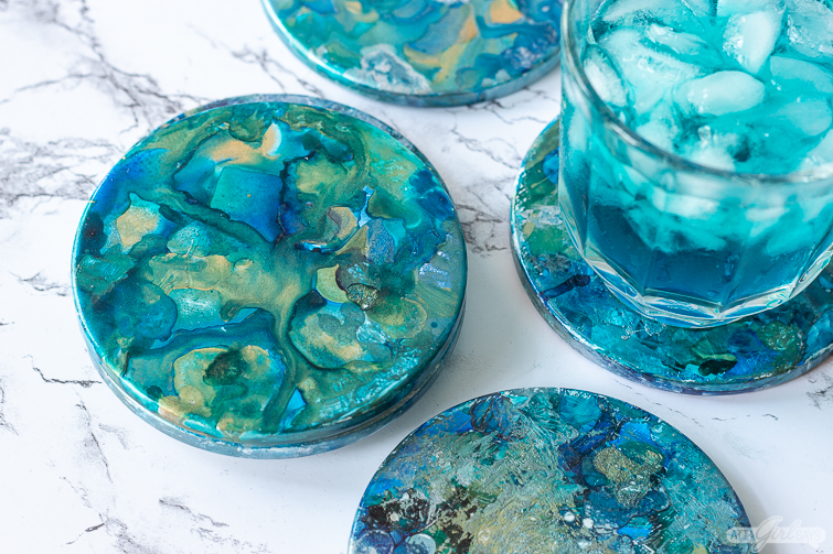 set of blue and aqua marbleized alcohol ink coasters
