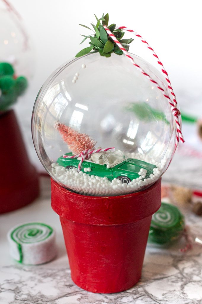 toy car with a Christmas tree on it inside a clear Christmas ornament
