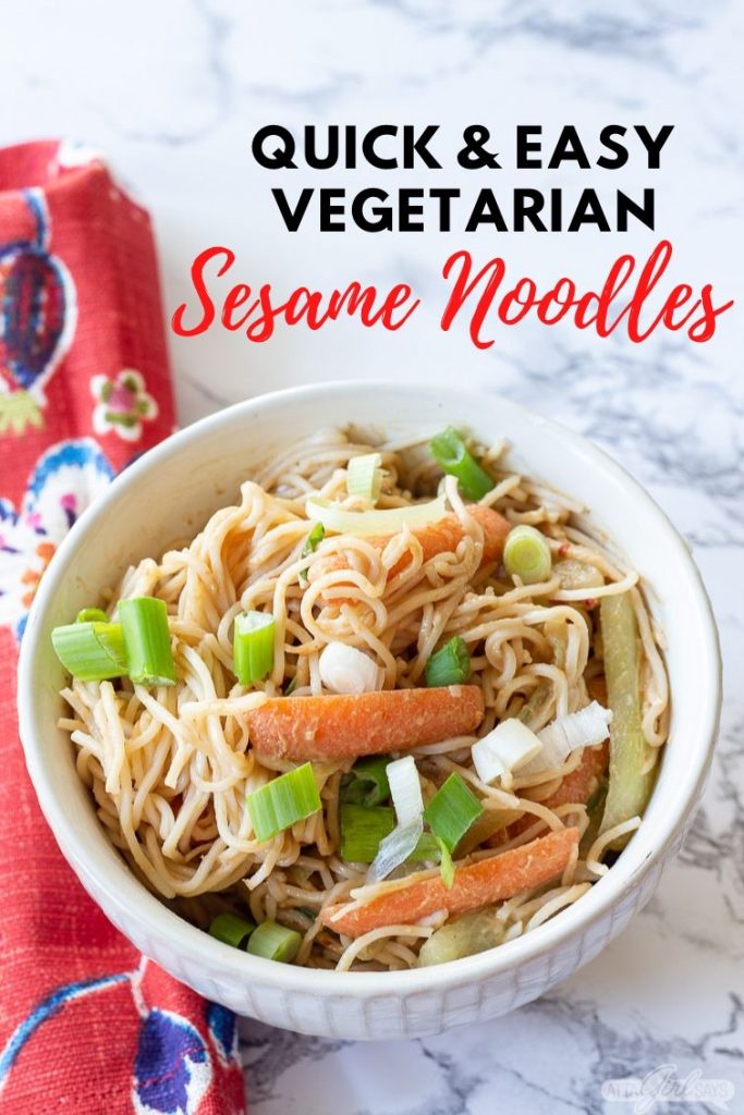 vegetarian cold sesame noodles in a bowl with green chopsticks and a red print napkin