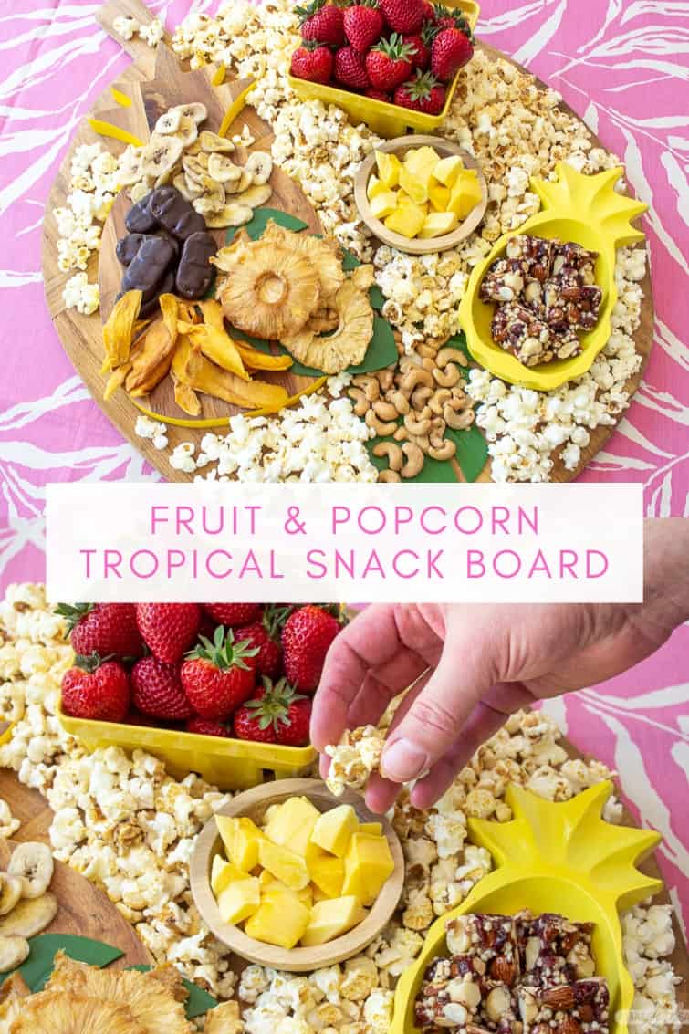 collage photo showing a man taking popcorn from a tropical charcuterie board with fruit, nuts and popcorn