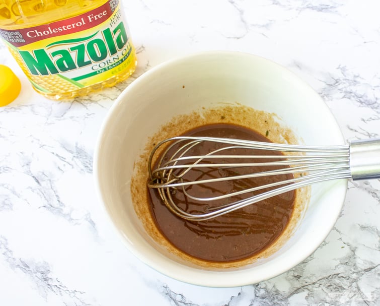 whisk in a bowl of dijon mustard balsamic marinade for pork