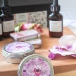 tins of homemade solid perfume with orchid fragrance oil