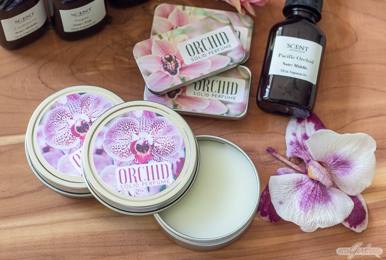 orchid solid perfume in metal tins