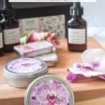 tins of homemade solid perfume with orchid fragrance oil