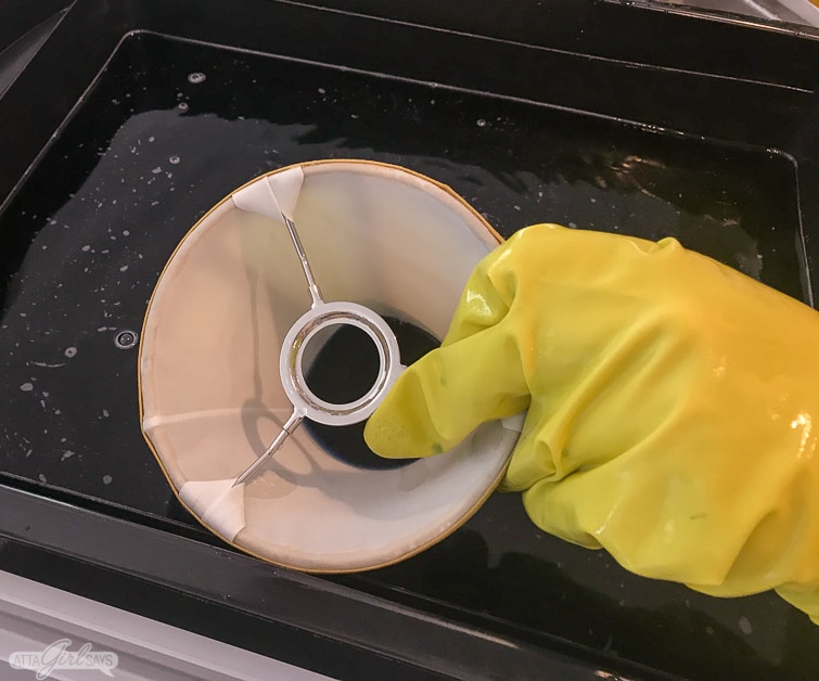 submerging a lamp shade in a dyebath