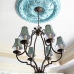 chandelier with blue shades and painted ceiling medallion