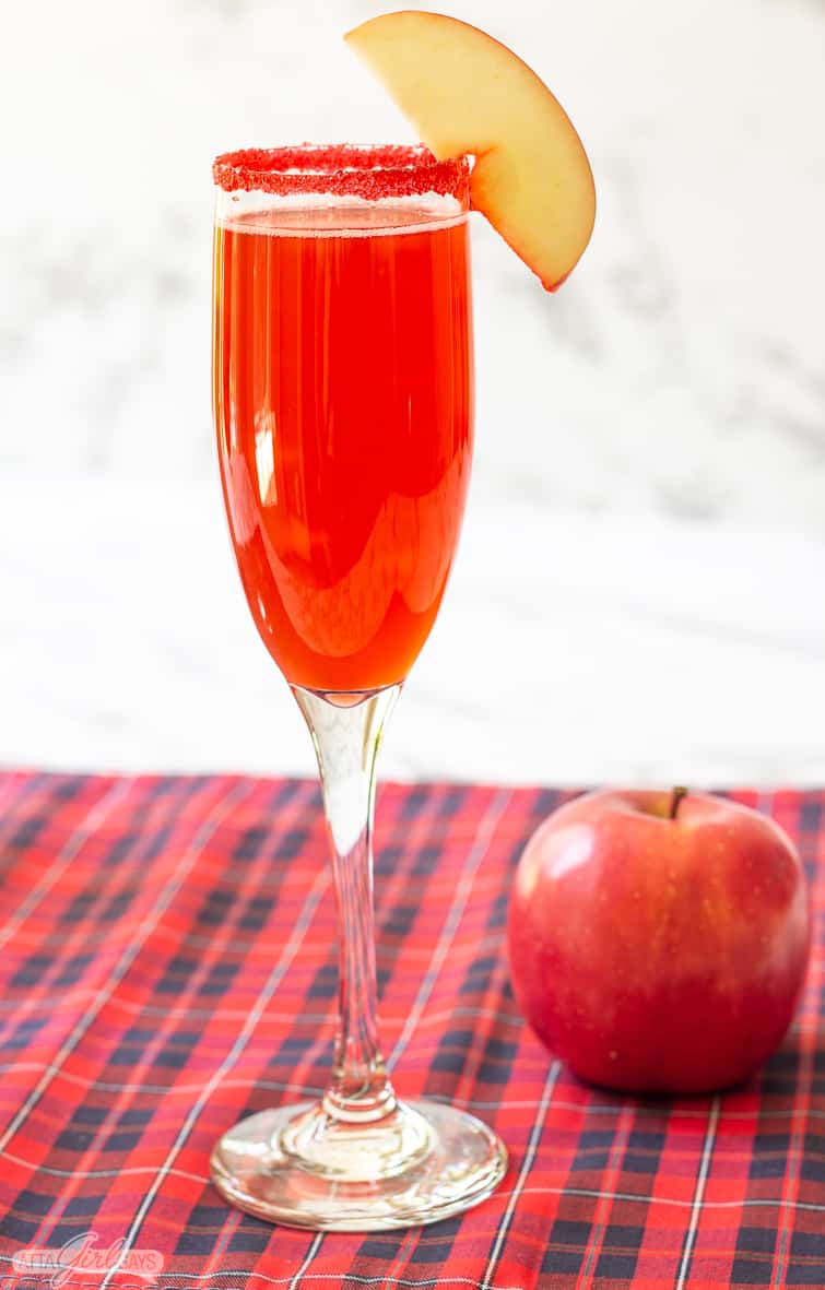 cinnamon apple cider cocktail in a champagne glass