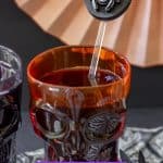 spider cocktail stirrer in a goblet