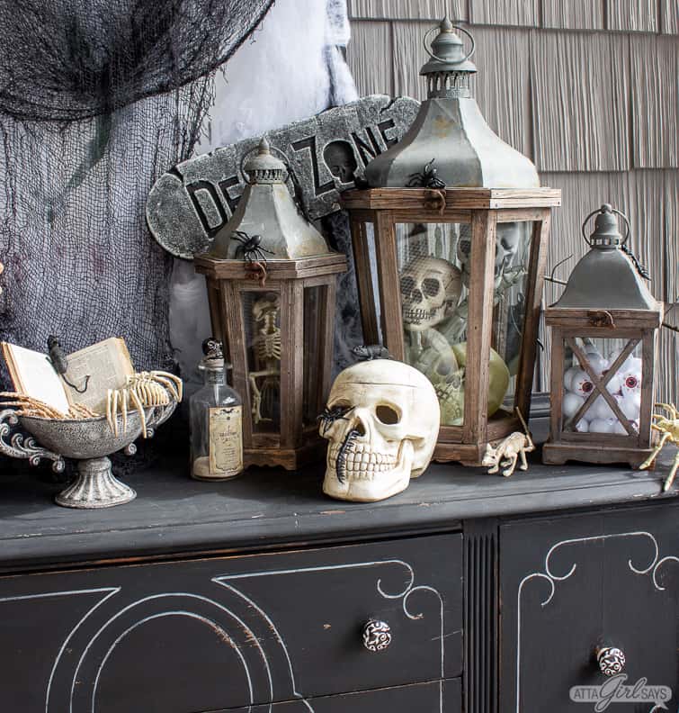 wooden lanterns filled with skulls and other Halloween decorations