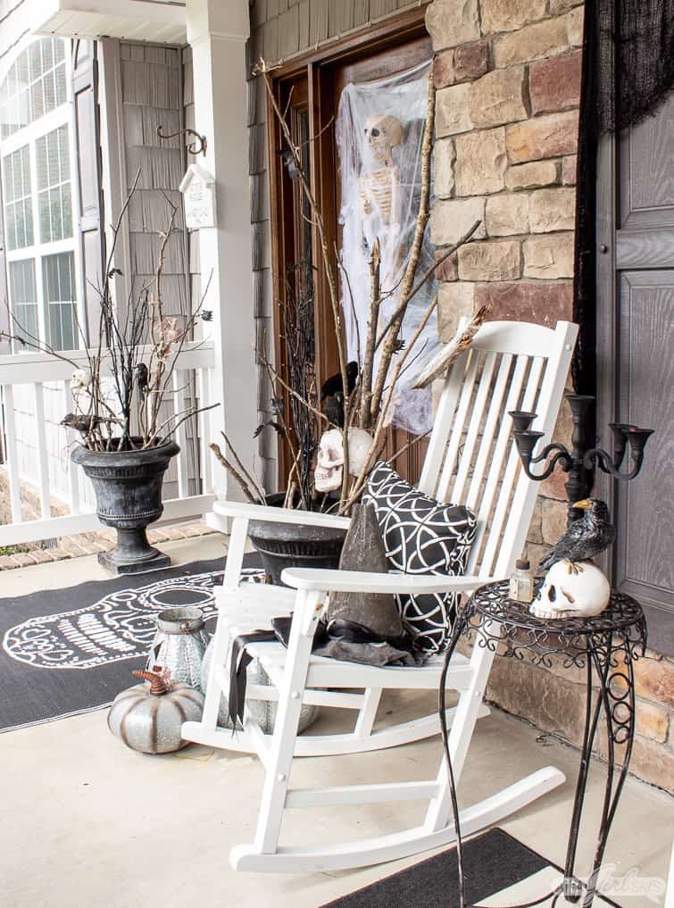 Halloween front porch decor with rocking chair and urns filled with sticks