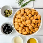 potatoes, capers, olives, olive oil, vinegar and herbs mis en place