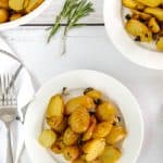 baking dish and two bowls with herb roasted potatoes