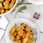 baking dish and two bowls with herb roasted potatoes