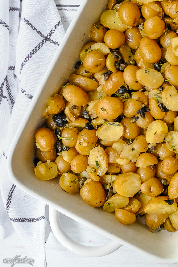 baby potatoes in a roasting dish with herbs