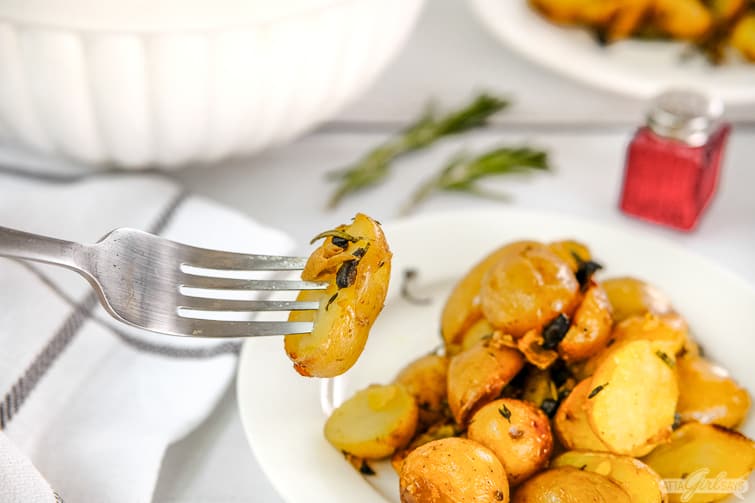 roasted baby potatoes on a fork and in a bowl