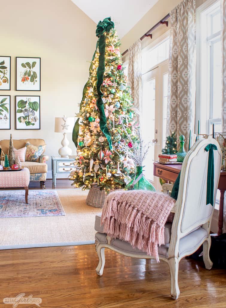 9 foot elegant Christmas tree decorated with glass ornaments and green velvet ribbon