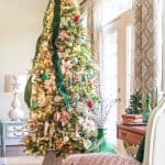 9 foot elegant Christmas tree decorated with glass ornaments and green velvet ribbon