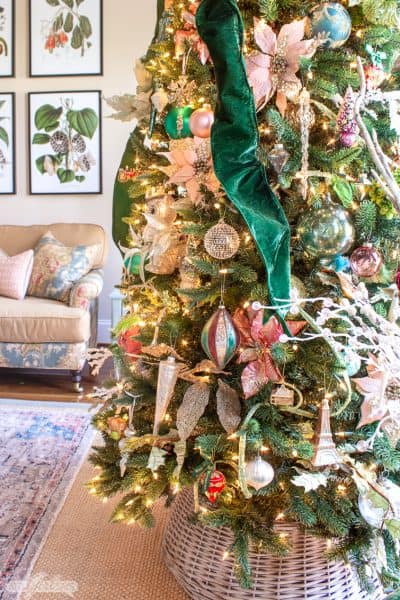 closeup of glass ornaments on a Christmas tree decorated with emerald green velvet ribbon