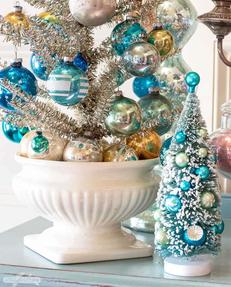 silver tinsel tree in a ceramic urn decorated with blue and aqua Shiny Brite ornaments