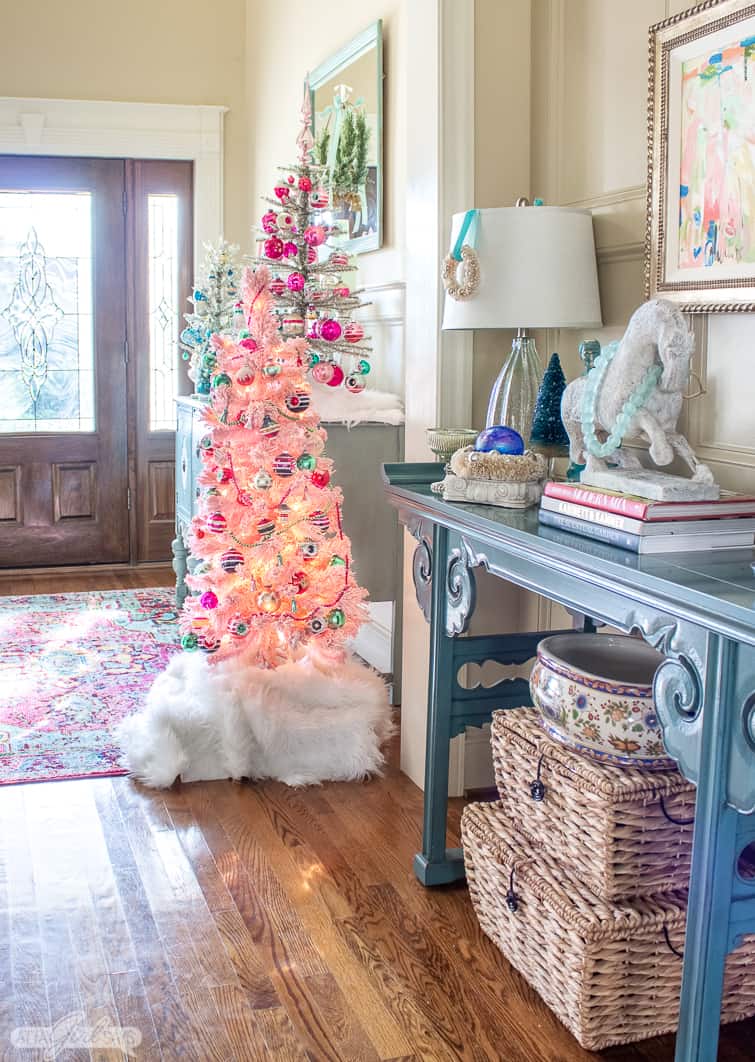interior scene of Christms decor with a pink tree decorated with Shiny Brite ornaments