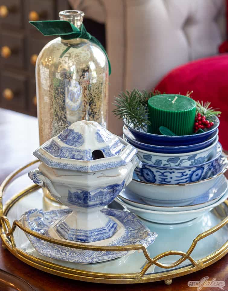 vintage blue and white pottery and mercury glass vase on a mirrored tray