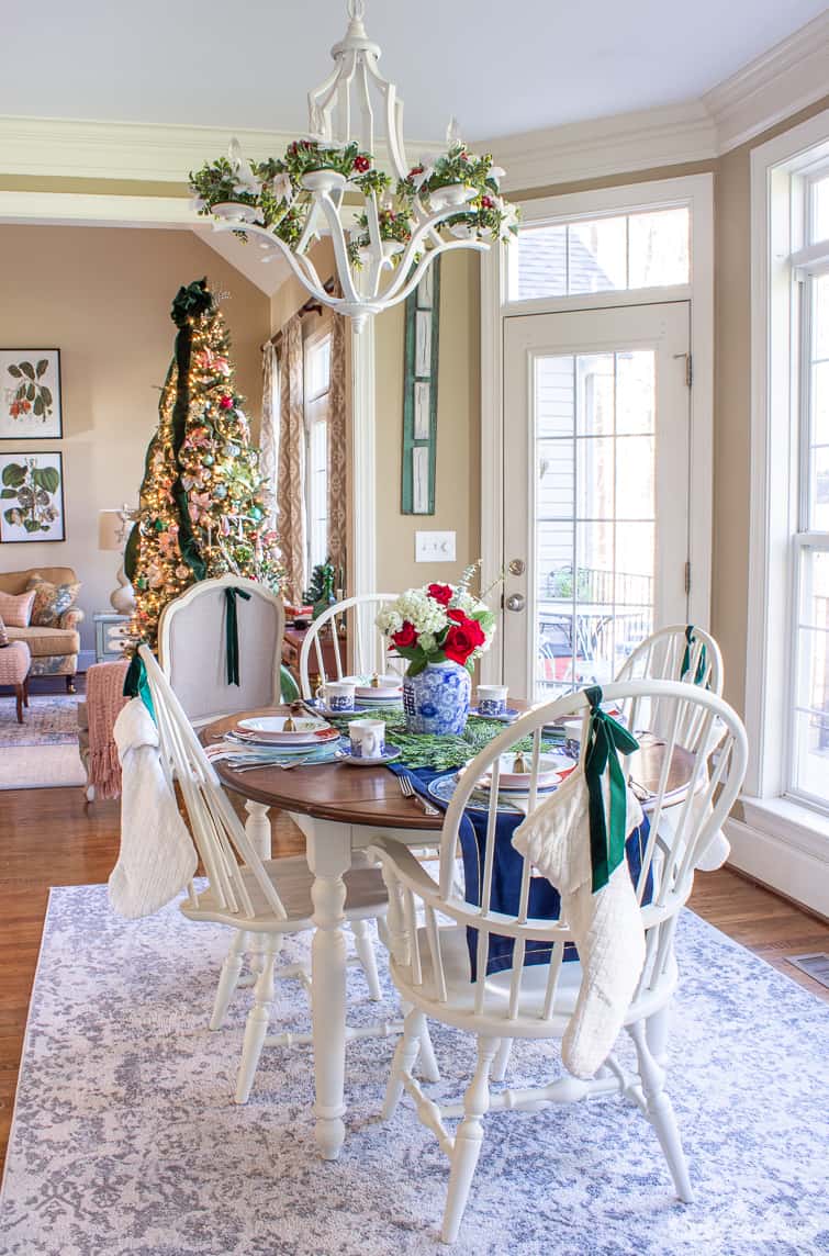 kitchen table decorated for Christmas overlooking an elegant Christmas tree