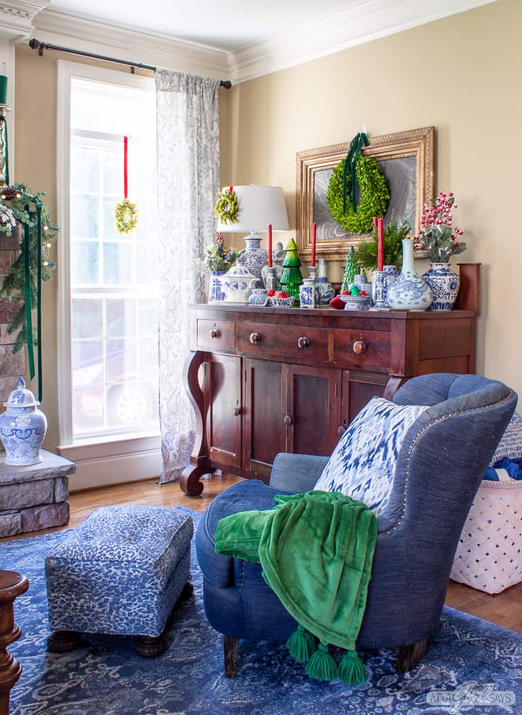 empire style buffet in a family room decorated with blue and white pottery for Christmas