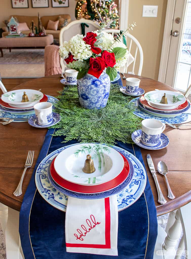 kitchen table decorated for Christmas with blue, white and green china