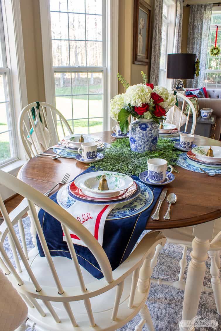kitchen table decorated for Christmas with blue, white and green china