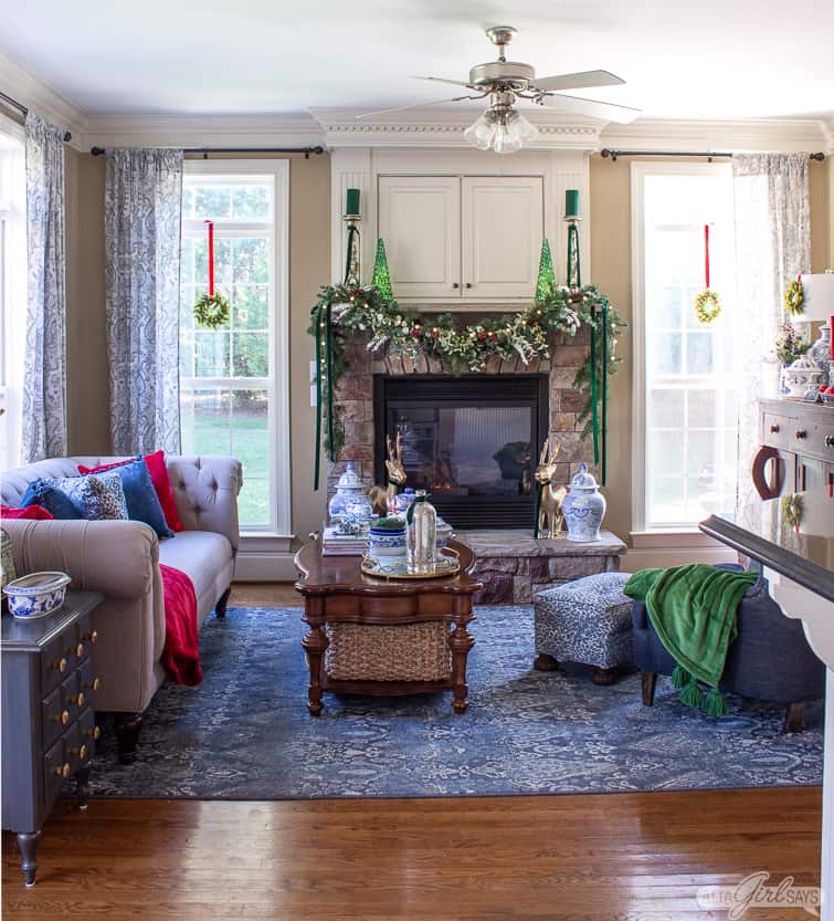 cozy family room with a stone fireplace decorated for Christmas