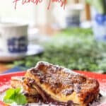chocolate french toast stuffed with hazelnut spread on a red rimmed plate