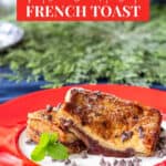 chocolate french toast stuffed with hazelnut spread on a red rimmed plate