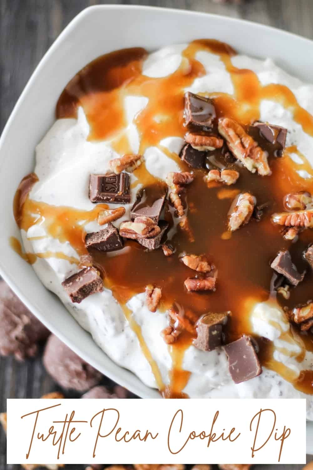 bowl of sweet cream cheese dip topped with pecans, chocolate and caramel