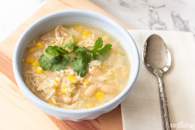 bowl of chicken and white bean chili with a spoon