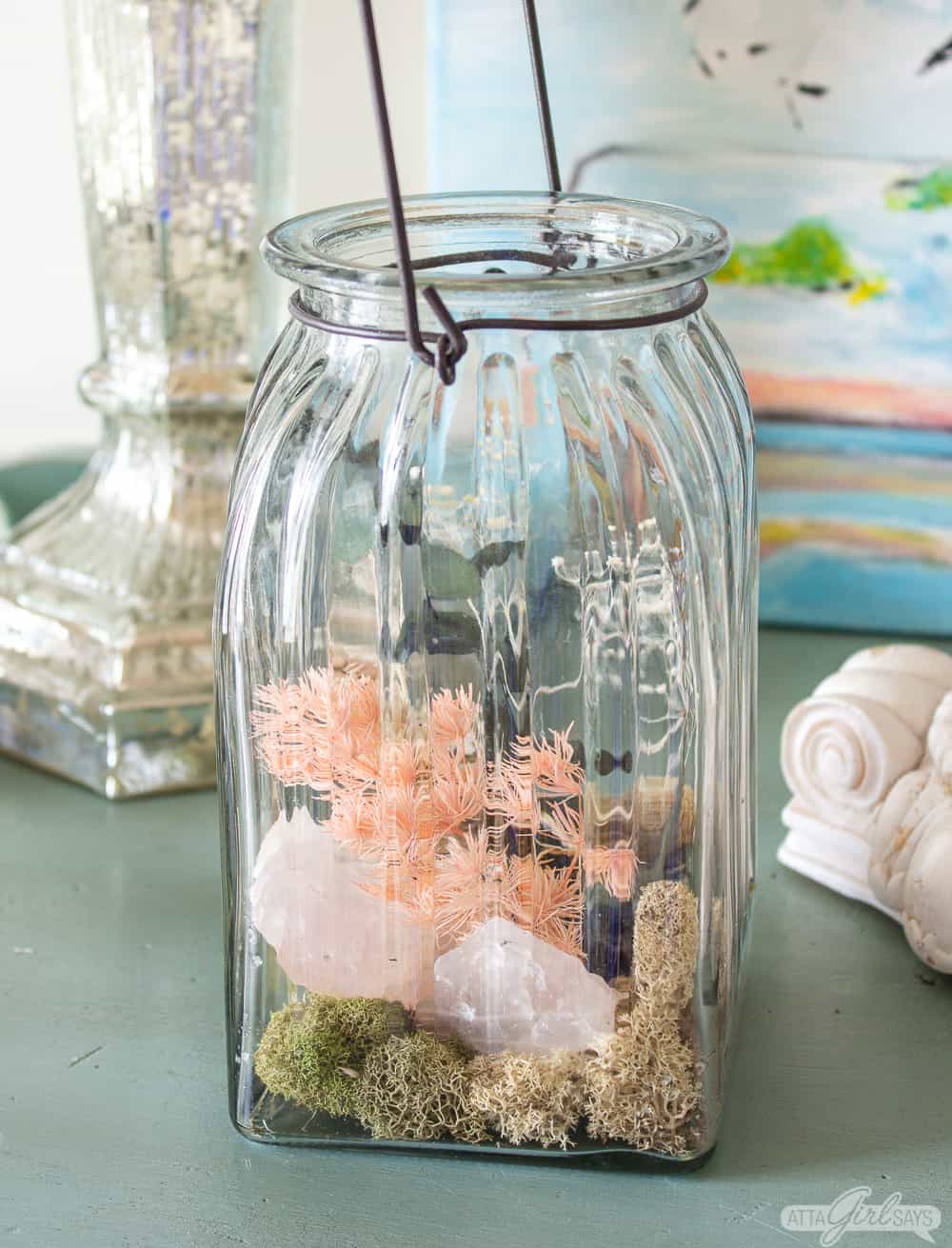 glass jar filled with homemade potpourri made from dried flowers, rocks and moss
