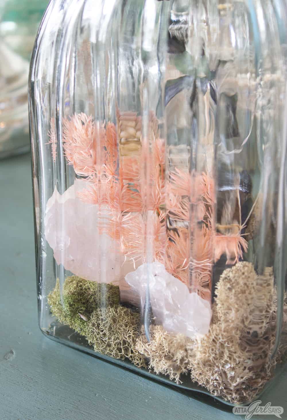 gemstock rocks, moss and dried botanicals in a glass scent jar