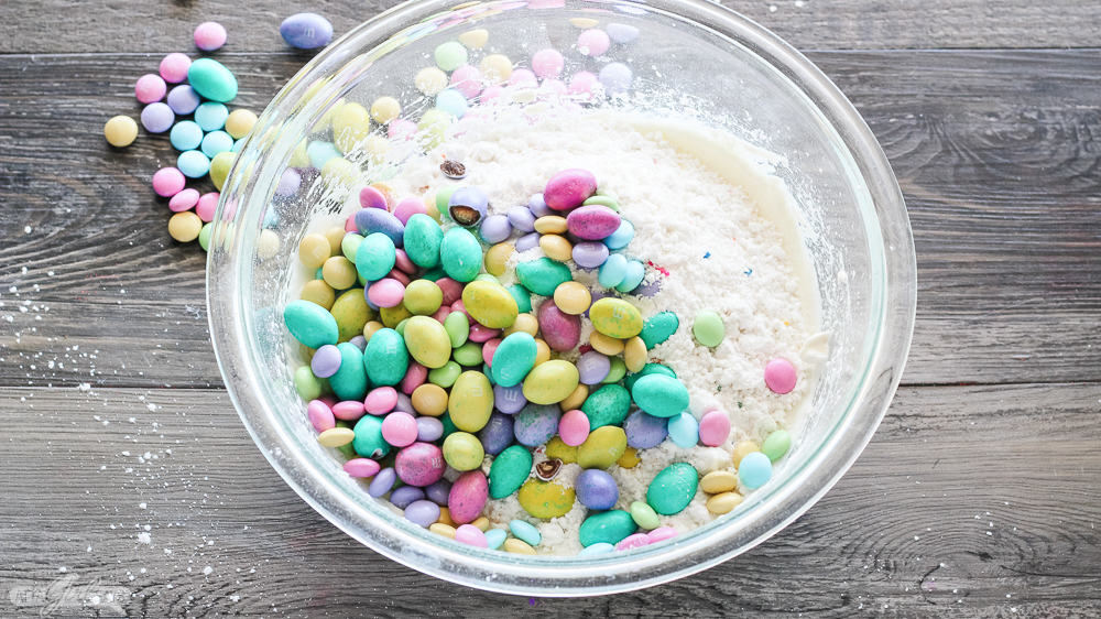 pastel M&Ms and Easter candy in a bowl of cake batter