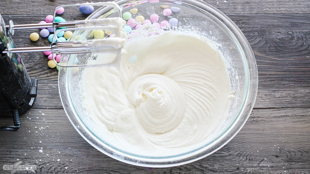 cream cheese and sugar blended together in a glass bowl