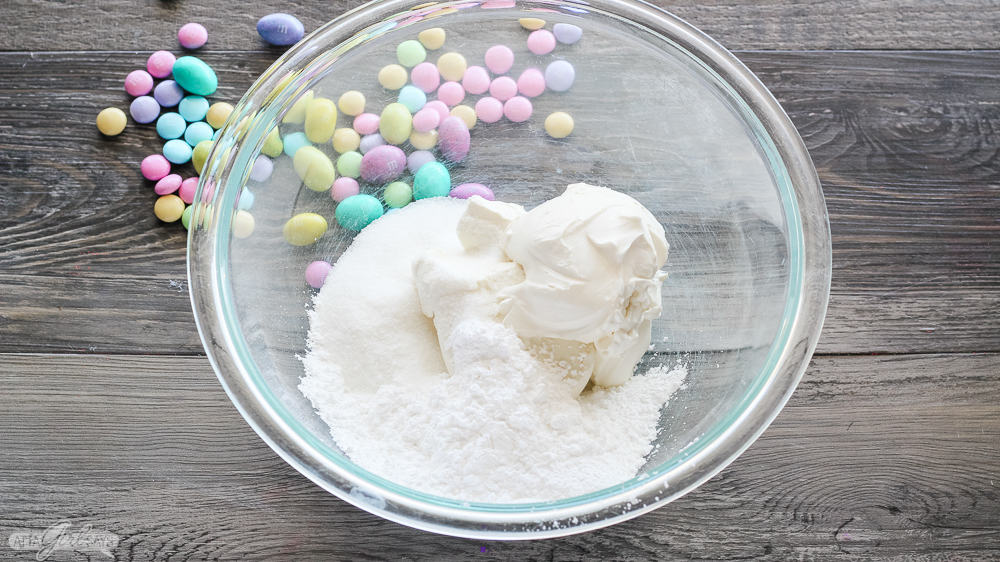 cream cheese and sugar in a bowl with chocolate Easter candies