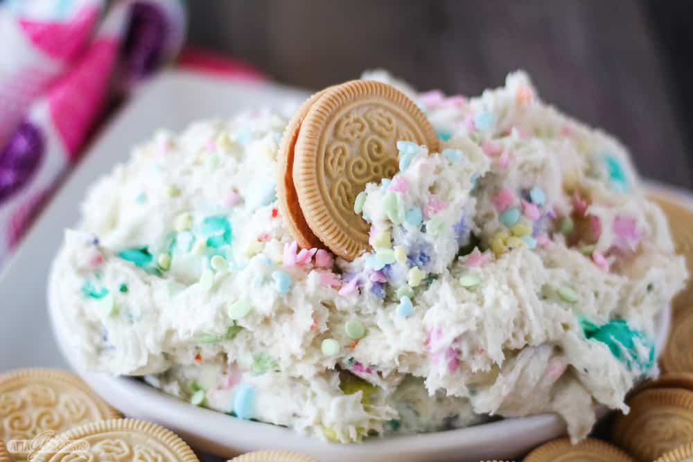 Golden Oreo cookie dipped in fluffy Easter candy funfetti dip