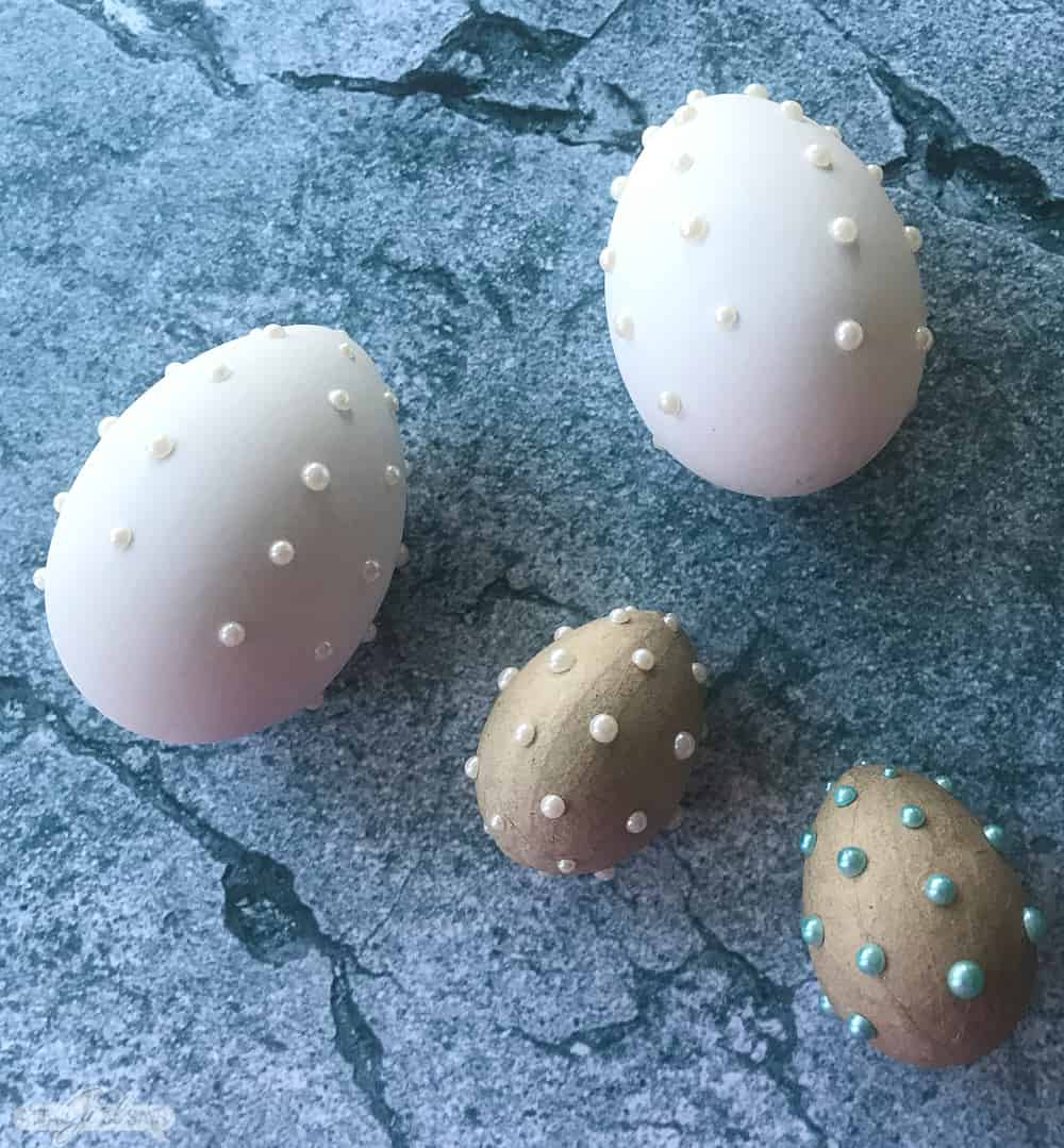 paper and plastic Easter eggs with adhesive pearls on them