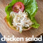 chicken salad, lettuce and a tomato slice in a baked wonton cup