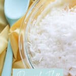 bowl of coconut and pudding mixture beside a green mixing spoon
