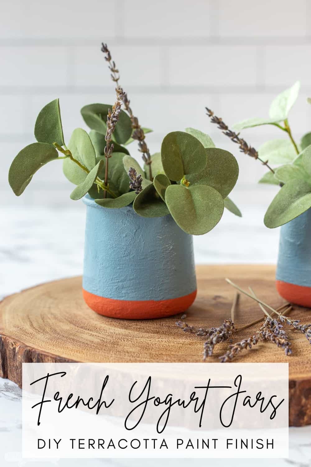 DIY painted French yogurt jar with greenery on a wooden charger