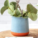 DIY La Fermiere French yogurt jar filled with eucalpytus and lavender on a wooden charger
